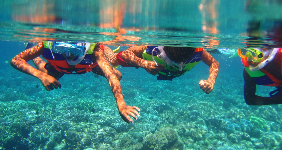 Three friends snorkeling in indonesian coastal waters Three friends snorkeling in indonesian coastal waters